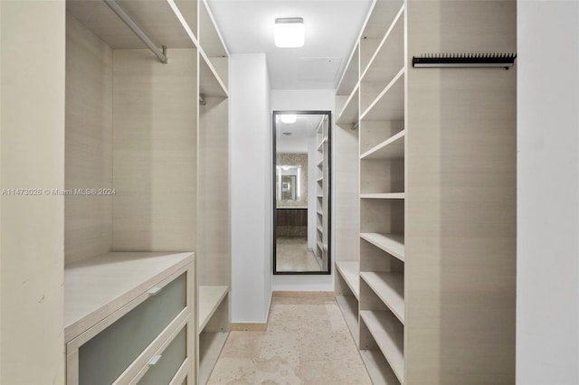 spacious closet featuring light tile flooring