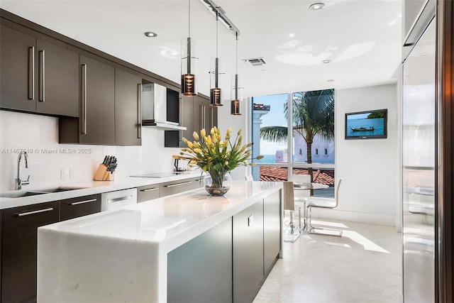 kitchen with sink, wall chimney range hood, hanging light fixtures, a center island, and black electric cooktop