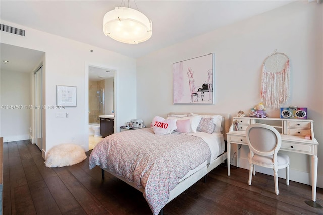 bedroom with ensuite bathroom and dark hardwood / wood-style flooring