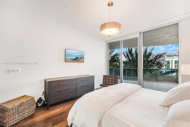 bedroom with floor to ceiling windows, dark hardwood / wood-style floors, and access to exterior