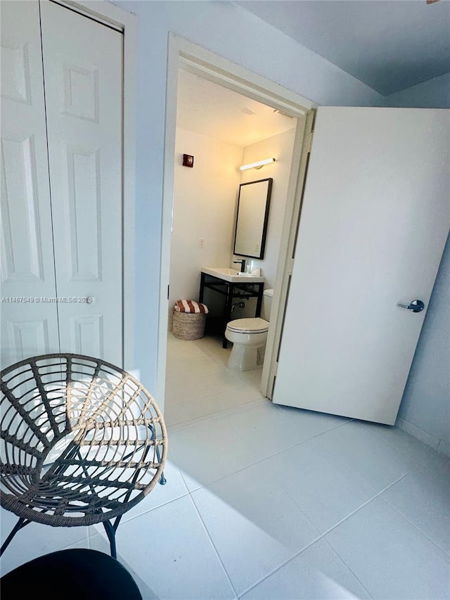 bathroom with tile patterned flooring, vanity, and toilet