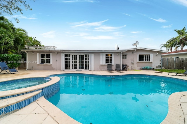 view of swimming pool featuring an in ground hot tub and a patio area