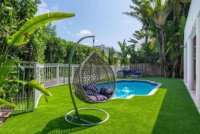 view of swimming pool featuring a yard