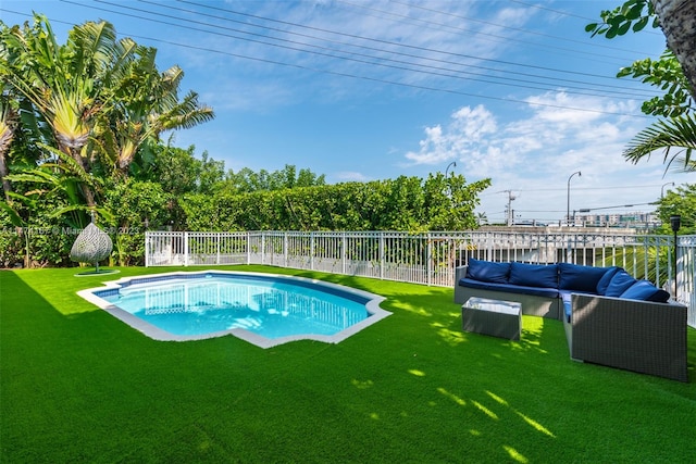 view of swimming pool featuring a lawn