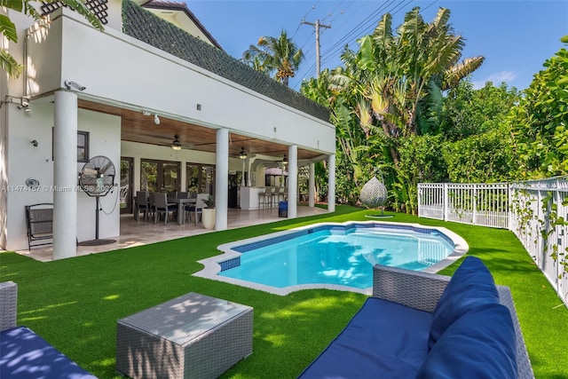 view of swimming pool featuring a yard, ceiling fan, and a patio