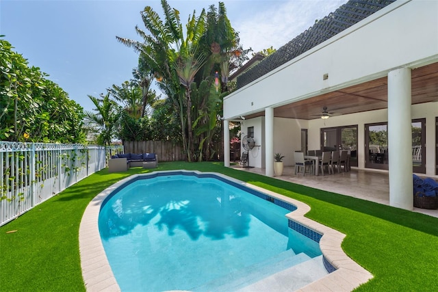 view of swimming pool with a lawn, ceiling fan, and a patio