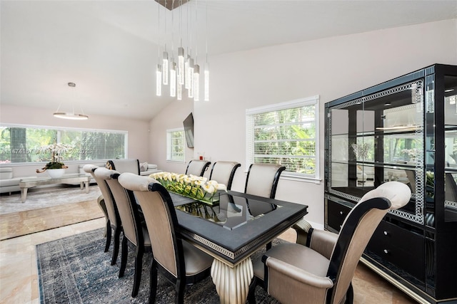 tiled dining area with lofted ceiling
