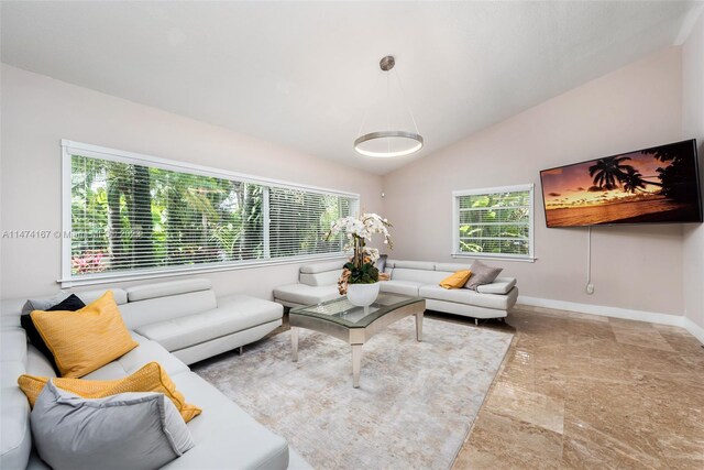 tiled living room featuring vaulted ceiling