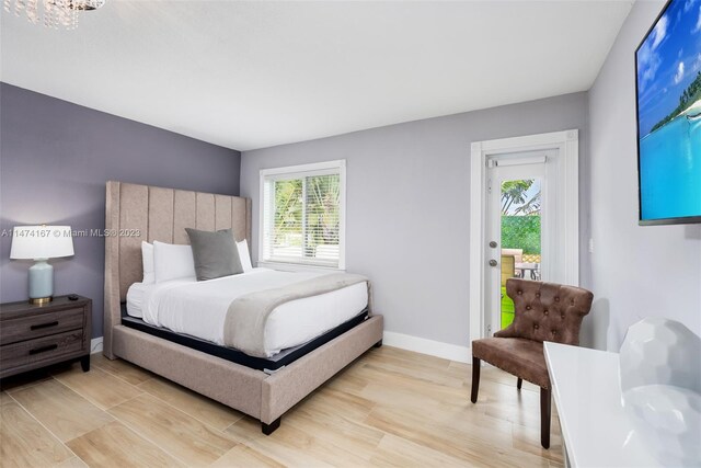 bedroom featuring light hardwood / wood-style floors and an inviting chandelier