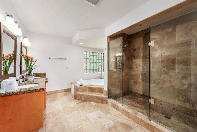 bathroom featuring tile floors, vanity with extensive cabinet space, and separate shower and tub