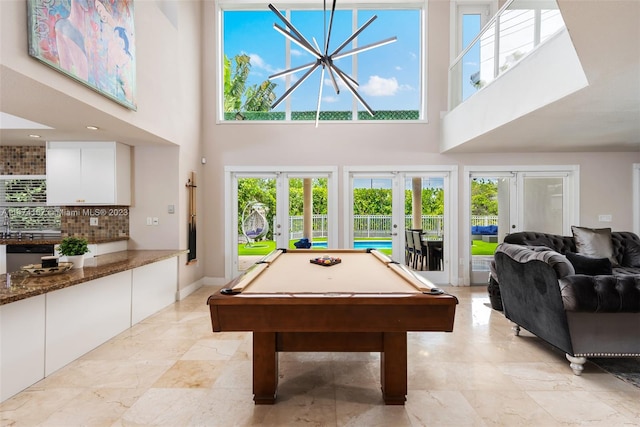 recreation room featuring light tile floors, plenty of natural light, pool table, and french doors