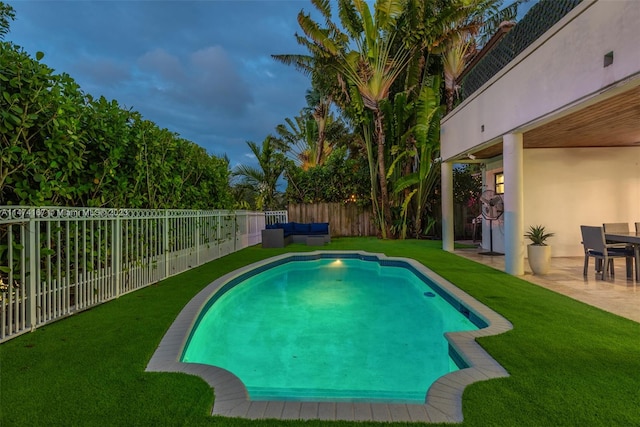 view of swimming pool featuring a lawn and a patio area
