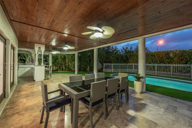 sunroom featuring ceiling fan and wood ceiling