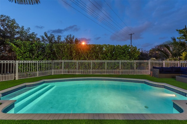 pool at dusk with a yard