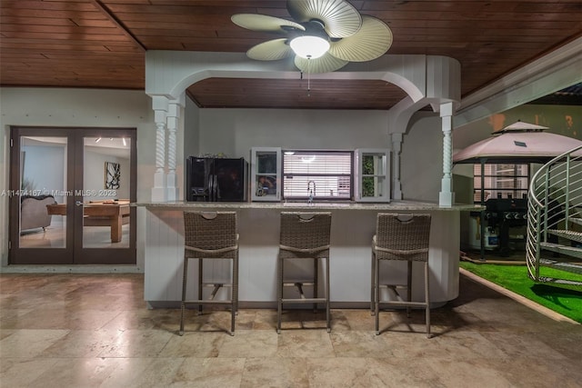 kitchen with black refrigerator with ice dispenser, ceiling fan, light tile flooring, wood ceiling, and french doors