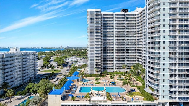 view of building exterior with a water view and a community pool