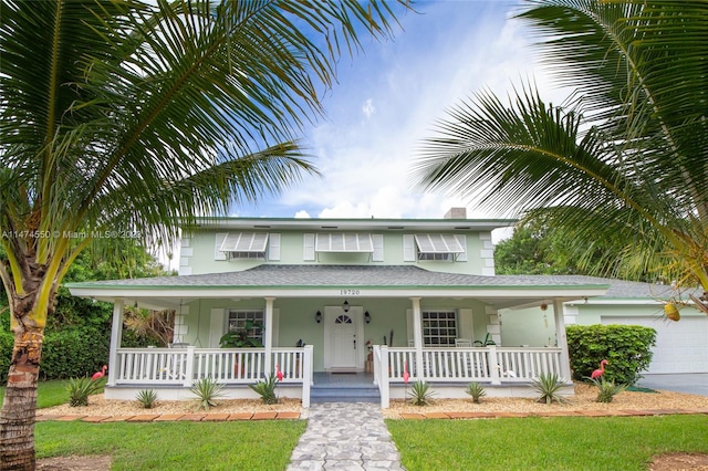 view of front of home featuring covered porch and a garage