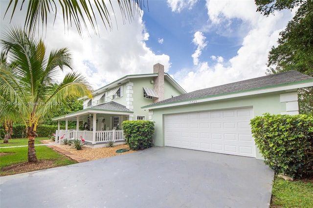 view of front of home featuring a porch and a garage