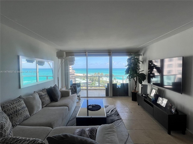 living room with a water view, light tile floors, and a wealth of natural light