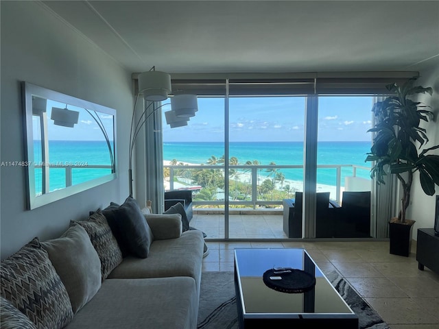 tiled living room featuring a water view