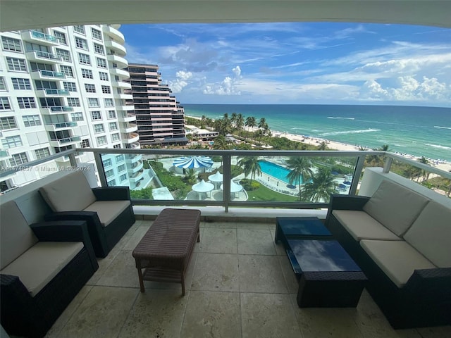 balcony with a water view and an outdoor living space