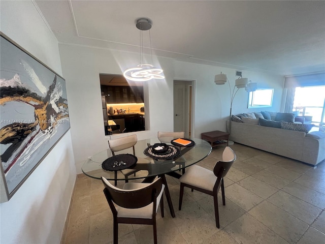 dining area with a chandelier and light tile floors