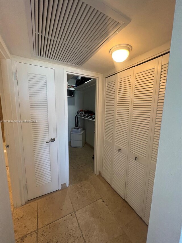 hallway featuring light tile floors