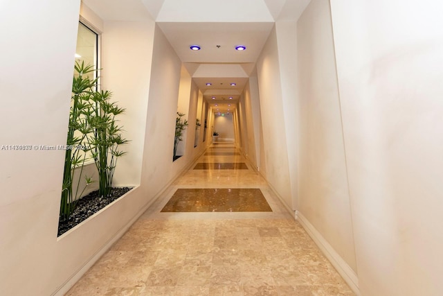 corridor featuring light tile floors