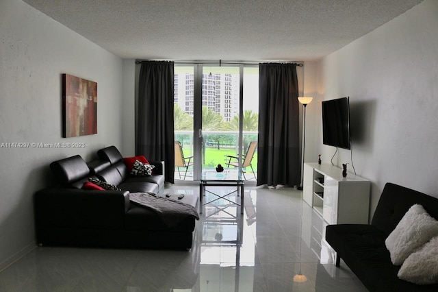 tiled living room featuring a textured ceiling