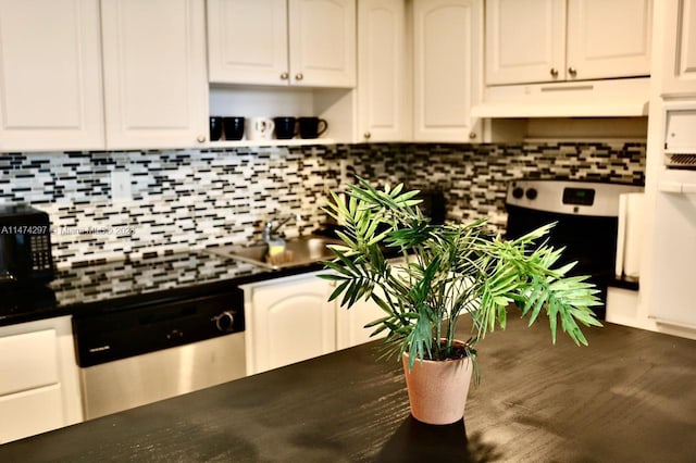 kitchen with white cabinetry, custom range hood, backsplash, and stainless steel appliances