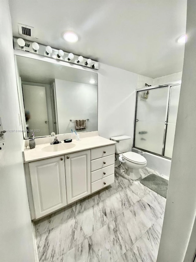 full bathroom featuring toilet, combined bath / shower with glass door, tile floors, and vanity