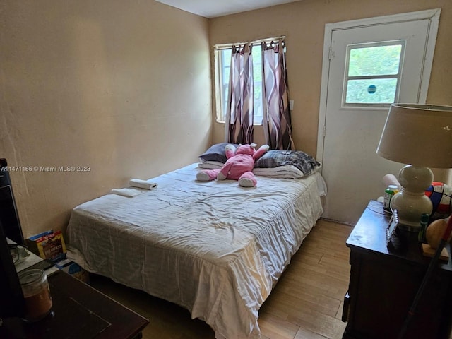 bedroom with wood-type flooring