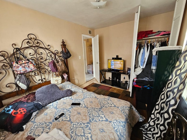 bedroom with a closet and dark wood-type flooring