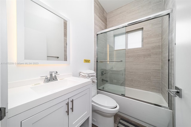 full bathroom featuring vanity, toilet, and enclosed tub / shower combo