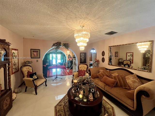 tiled living room with an inviting chandelier and a textured ceiling