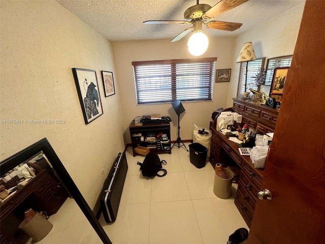 bedroom with ceiling fan, light tile floors, and multiple windows