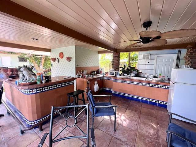 view of terrace featuring a bar and ceiling fan