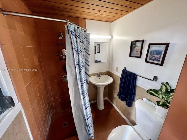 bathroom with toilet, wood ceiling, walk in shower, tile flooring, and sink