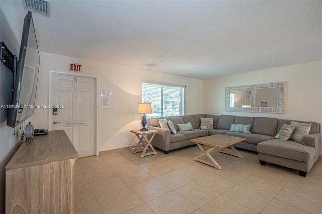 living room with light tile floors and a textured ceiling