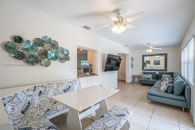 tiled living room with ceiling fan