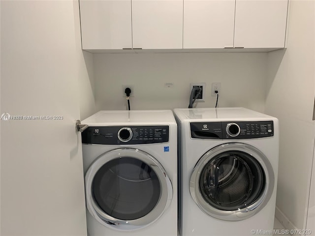 laundry room featuring washing machine and clothes dryer, hookup for a washing machine, cabinets, and electric dryer hookup