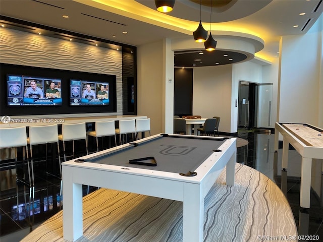 recreation room featuring billiards, a tray ceiling, and dark tile floors