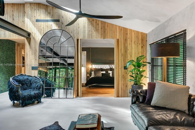 interior space with concrete flooring, vaulted ceiling, and ceiling fan