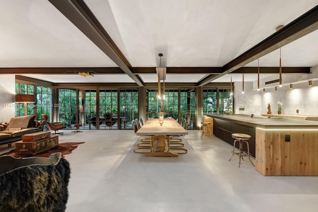 dining space with vaulted ceiling with beams