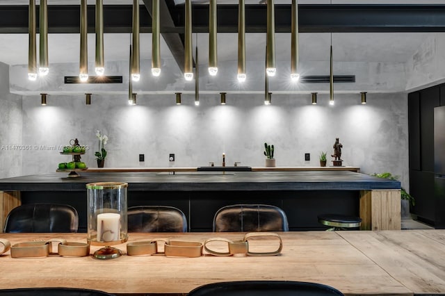 bar featuring decorative light fixtures and rail lighting