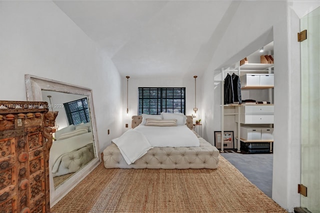 bedroom featuring lofted ceiling and carpet floors