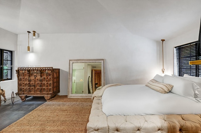 bedroom with dark carpet and lofted ceiling