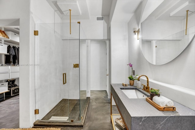 bathroom featuring concrete flooring, vanity, and a shower with shower door