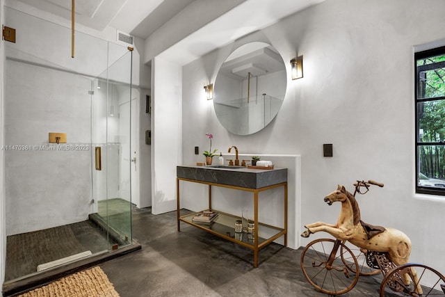 bathroom featuring concrete floors, walk in shower, and vanity