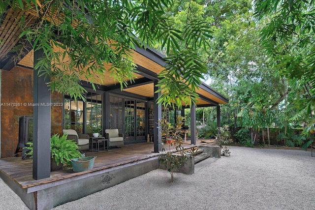 view of terrace with a wooden deck and french doors